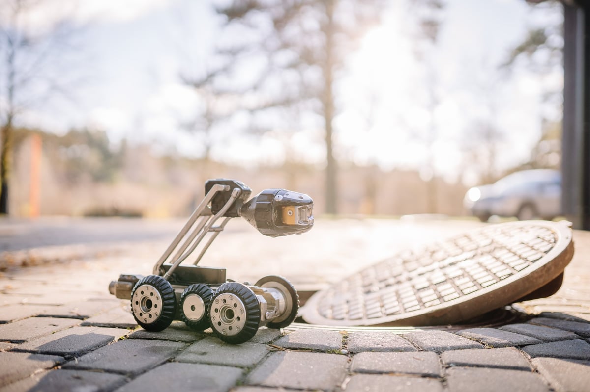 Professional plumber using camera inspection equipment in Edmonton