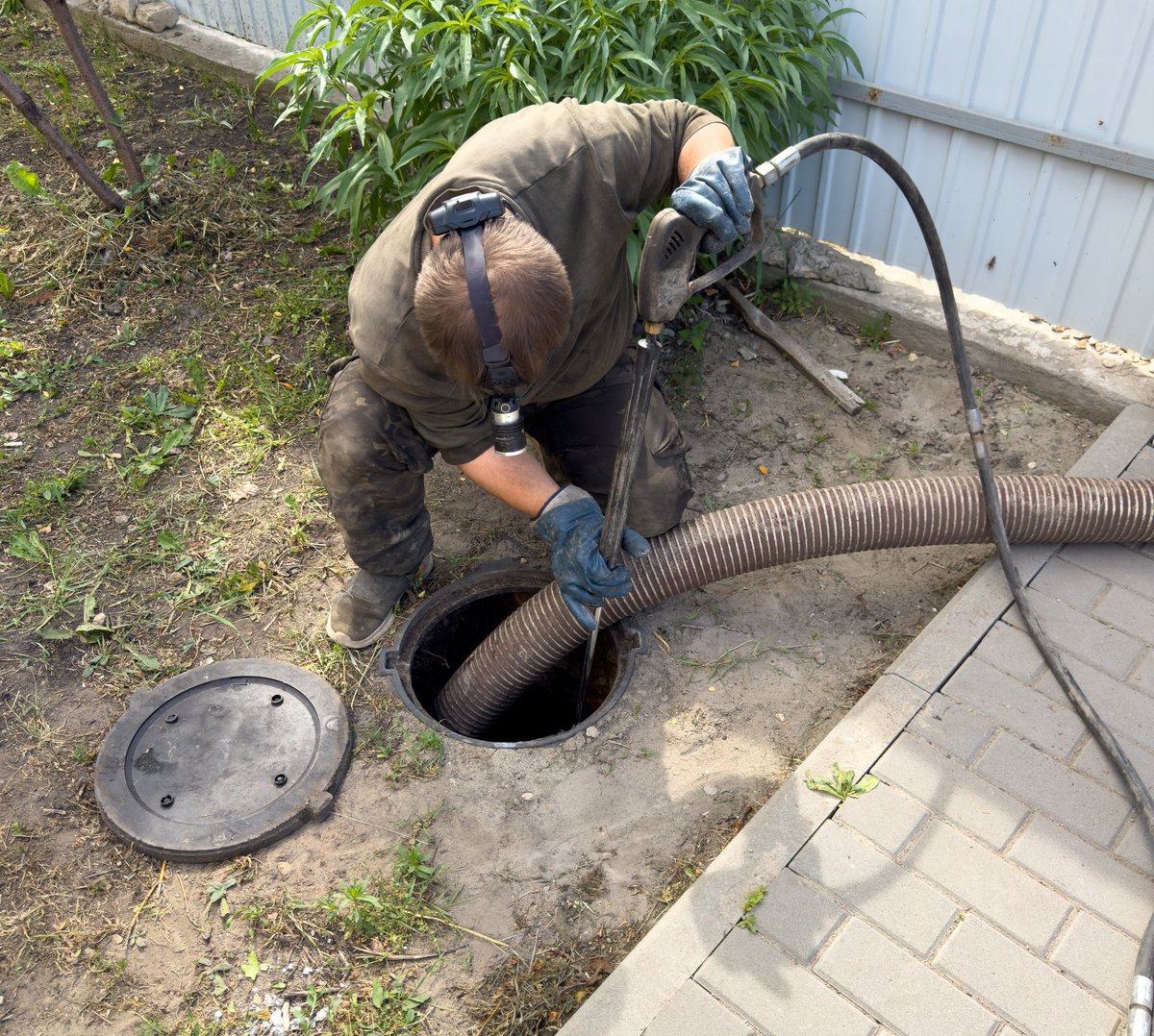 Professional plumber working on drain cleaning with expertise and care